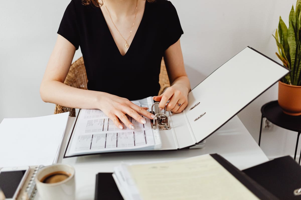 Filing bookkeeping records into a binder